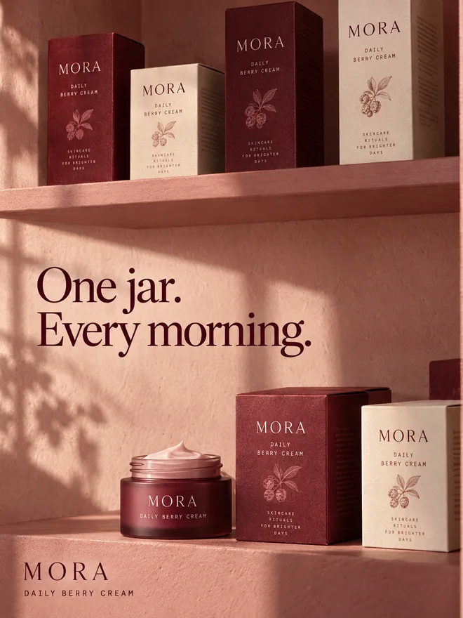 MORA berry cream and skincare cartons on rose shelves